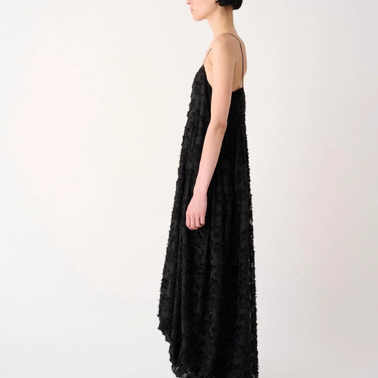 Woman wearing a black floral dress on a white background