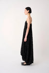Woman wearing a black floral dress on a white background