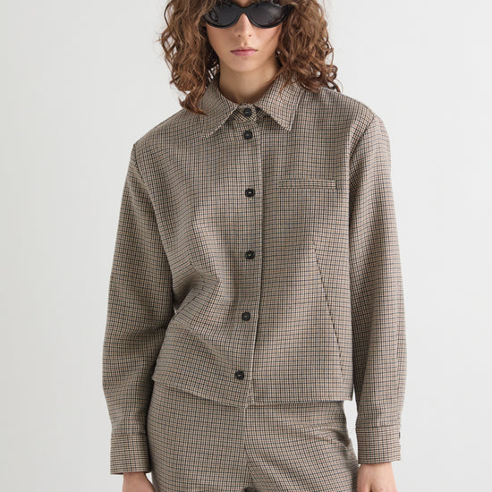 Check collared jacket with long sleeves worn with matching trousers