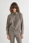Check collared jacket with long sleeves worn with matching trousers