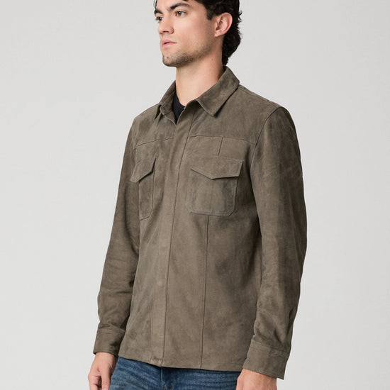 Man wearing a brown suede jacket and blue jeans side view
