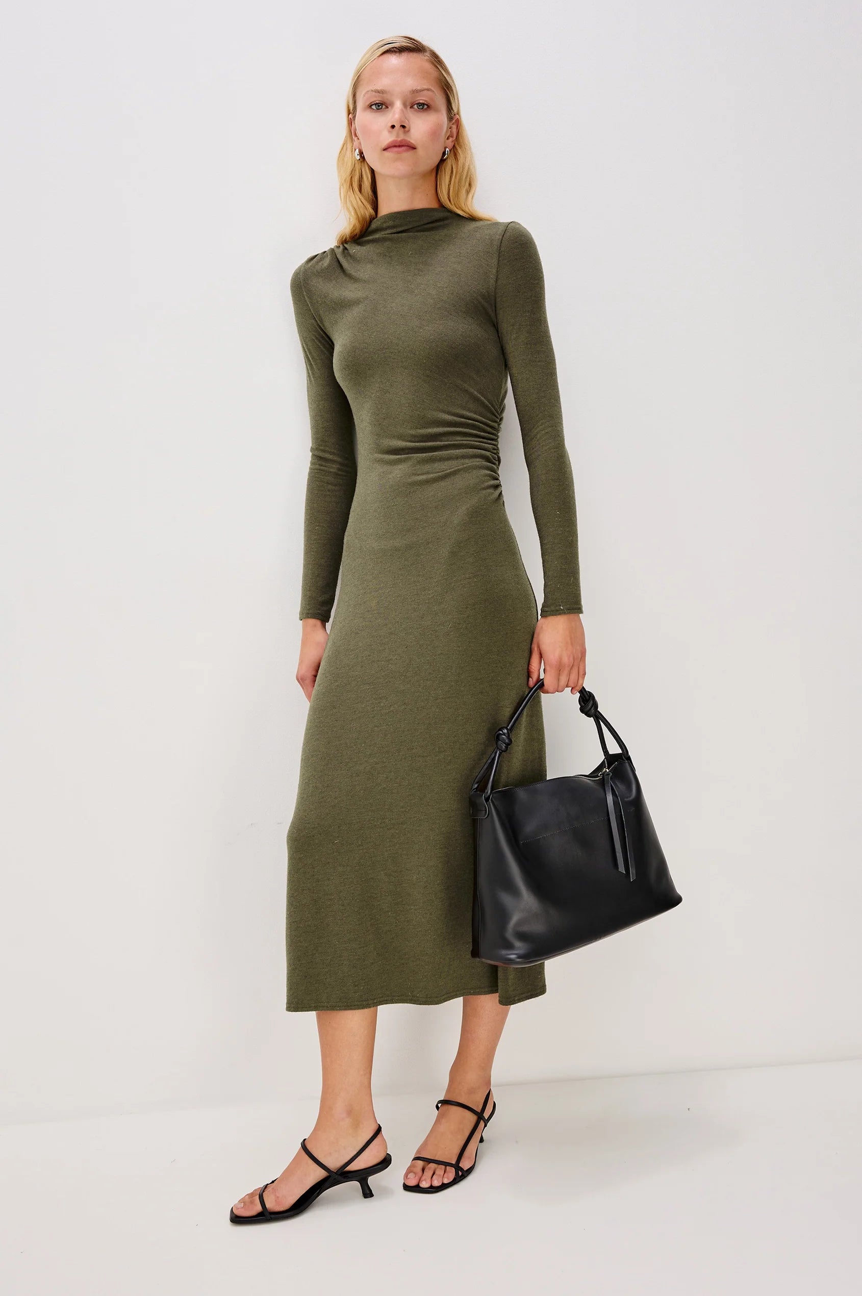 olive green bodycon dress with rouche detailing and mid length with long sleeves