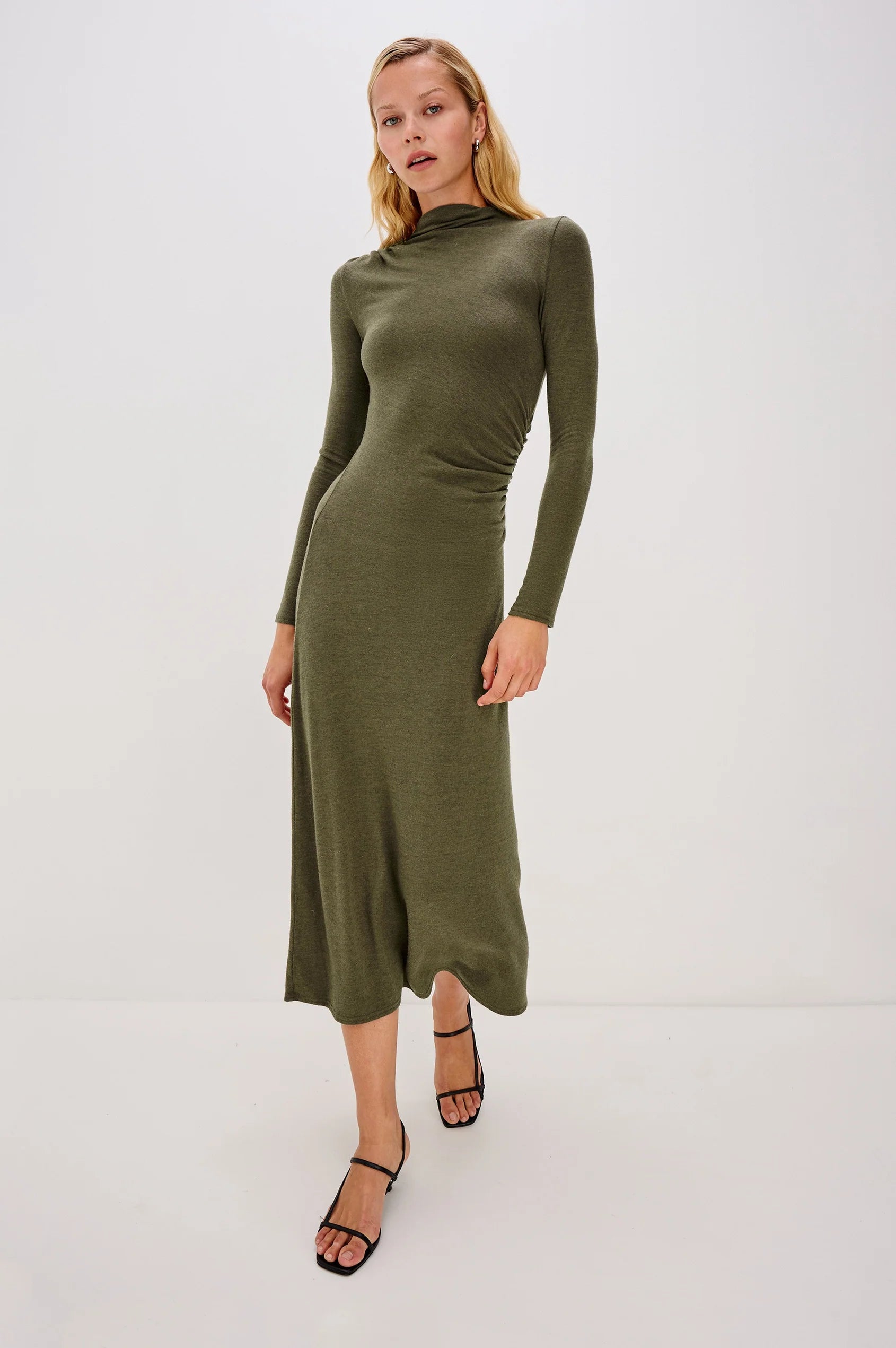olive green bodycon dress with rouche detailing and mid length with long sleeves model shot