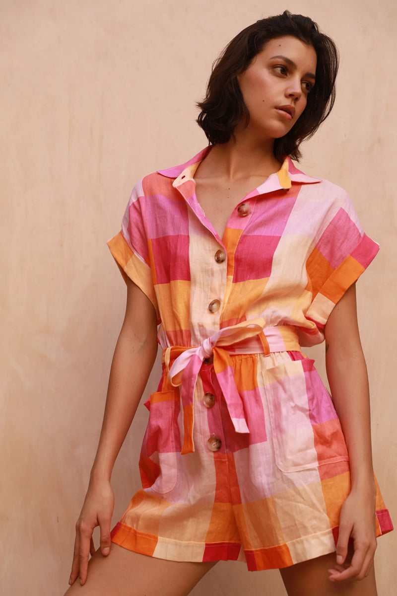 Short playsuit with elasticated waist in pink and orange check linen fabric with chunky buttons and classic collar