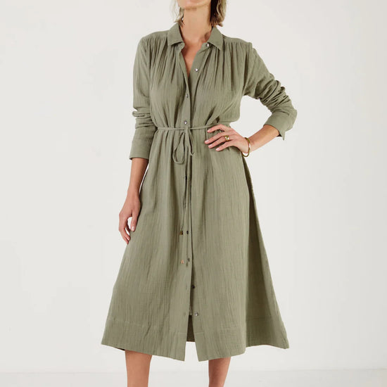 Woman wearing a green dress by Mondo Corsini with a white background