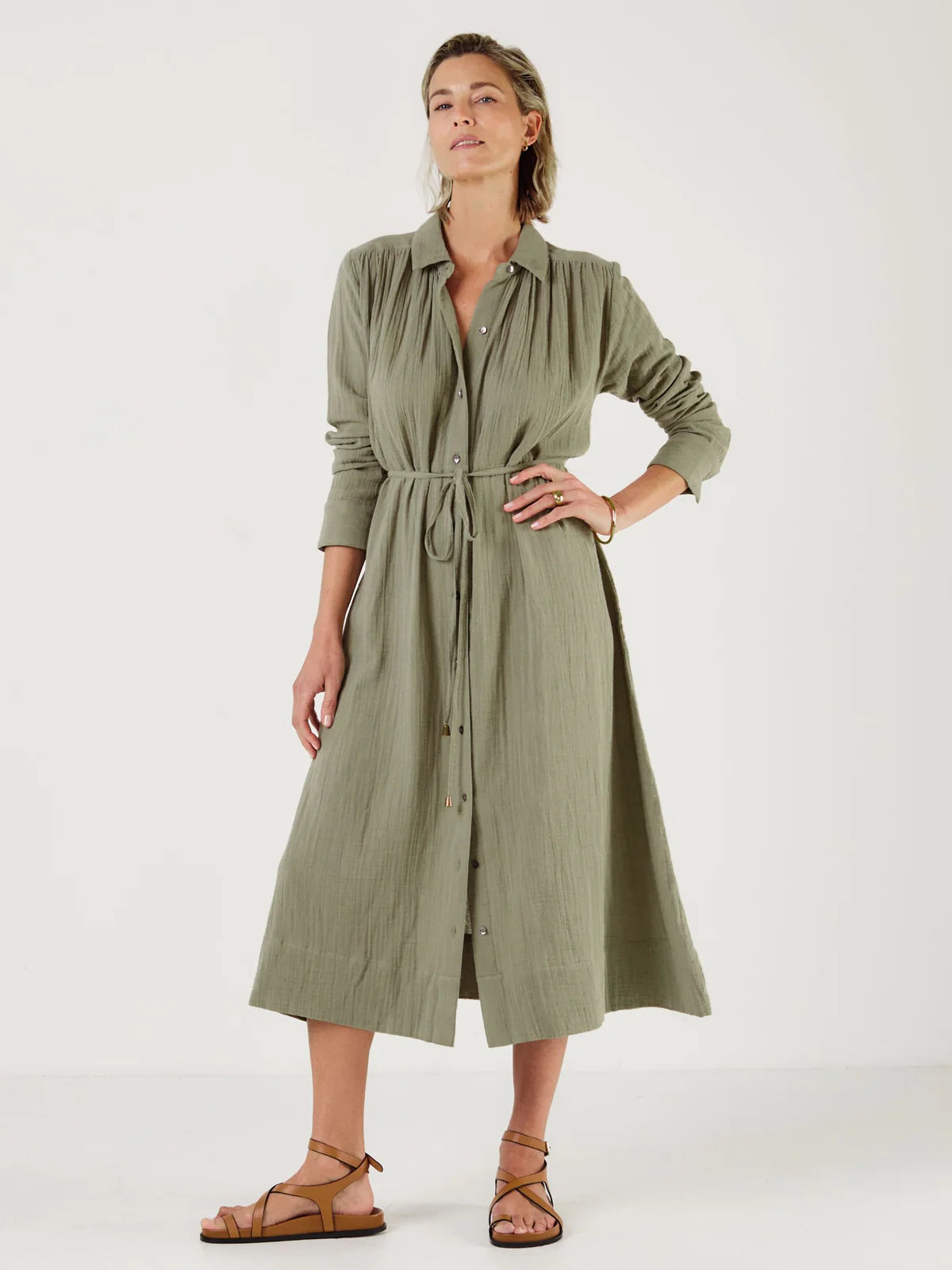 Woman wearing a green dress by Mondo Corsini with a white background