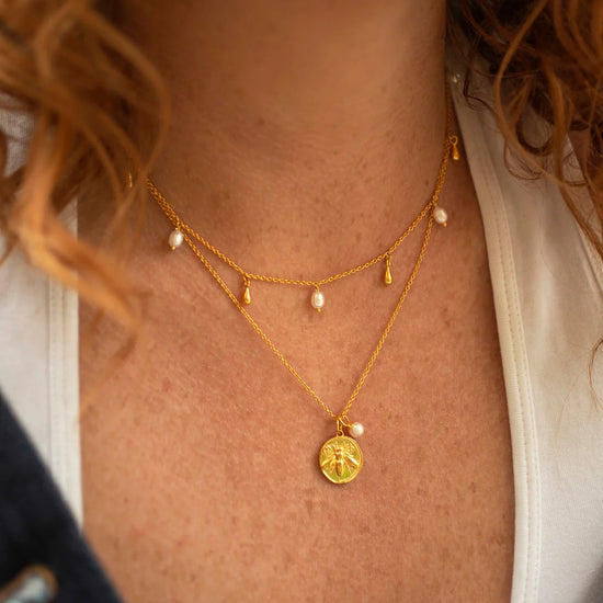 Gold bee coin pendant necklace with small rice pearl on gold chain