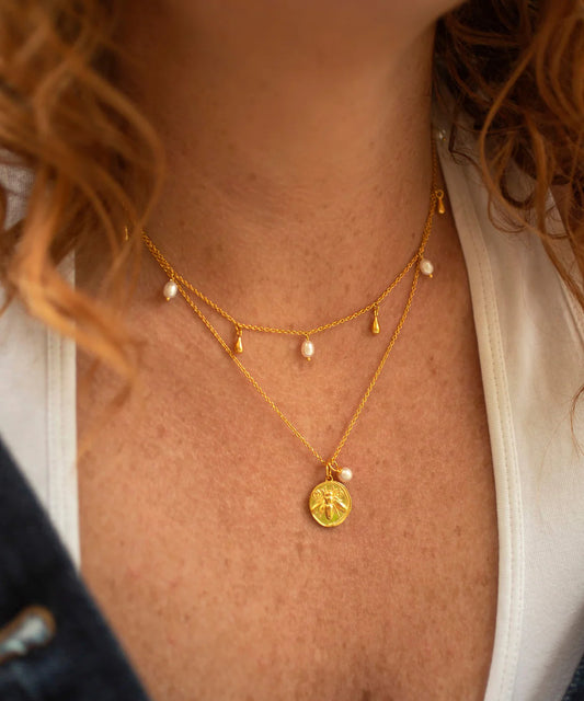 Gold bee coin pendant necklace with small rice pearl on gold chain