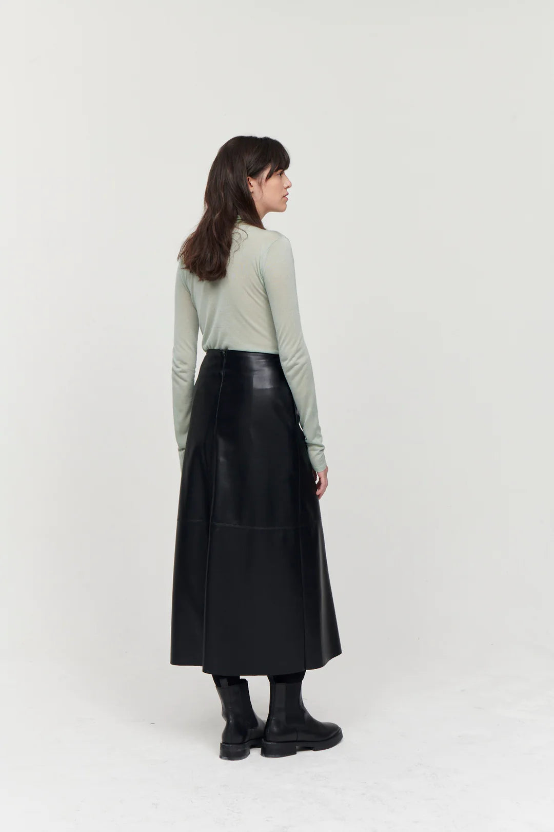 A line midi vegan leather black skirt with panel features and a centre back zip fastening with inseam side pockets