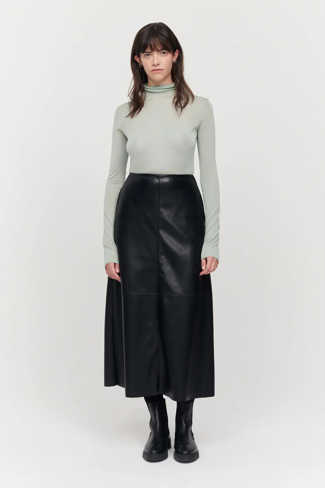 A line midi vegan leather black skirt with panel features and a centre back zip fastening with inseam side pockets