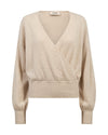 A light beige knit wrap sweater with a V-neckline, long sleeves, and ribbed cuffs and hem, shown against a plain white background.