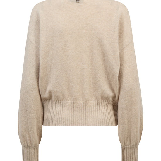 A light beige knit sweater with a crew neck, dropped shoulders, and ribbed hem and cuffs, shown against a plain white background.