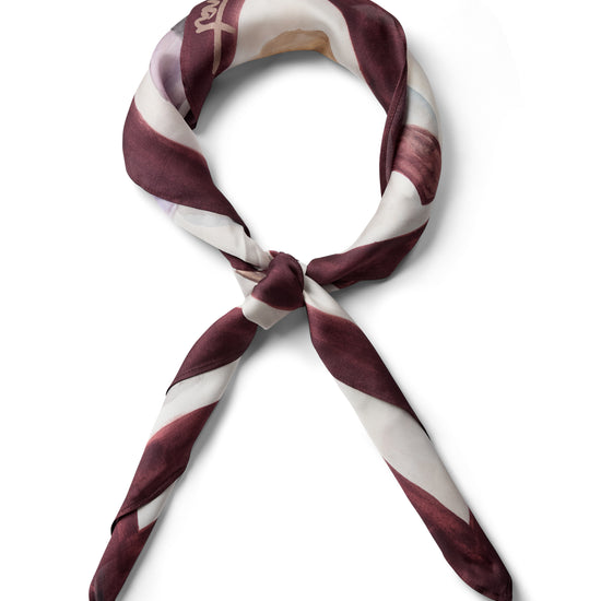 Scarf twisted into a knot on a white background