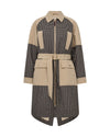 A colour-blocked mid-length coat featuring a beige collar, waist tie belt, and large front flap pockets, combined with black and beige checkered panels on the body and sleeves, shown against a plain white background.