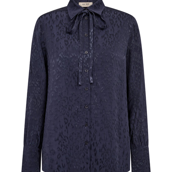 A dark navy blue long-sleeve button-up shirt with a subtle tonal leopard print and a tie-neck collar, shown against a plain white background.