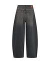 Back view of dark gray wide-leg denim jeans with a brown leather patch on the waistband, shown on a plain white background.