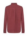 flat lay of a red linen shirt from behind on a white background