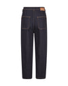 Back view of dark indigo denim jeans with contrast tan stitching and a brown leather patch on the back waistband, shown on a plain white background.