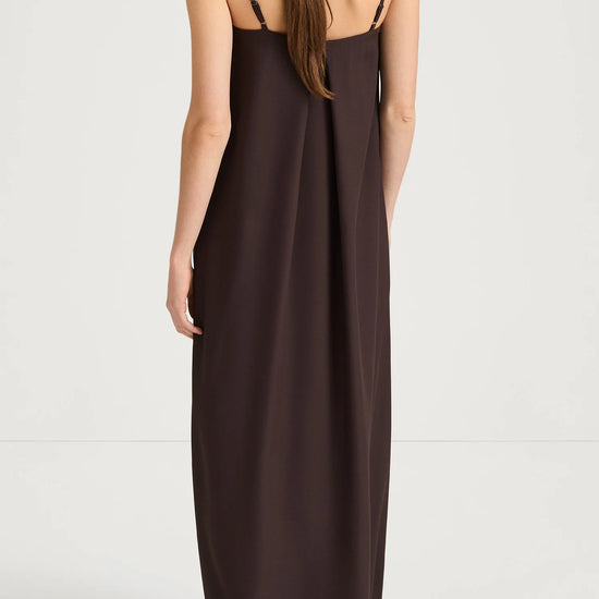 Brown slip dress worn by a model on a white background