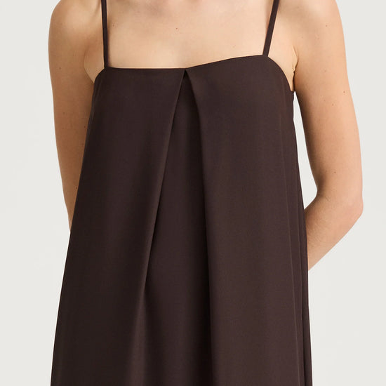 Brown slip dress with thin straps on a white background