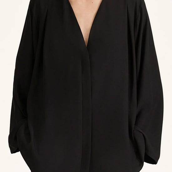 Black blouse with a deep neckline on a white background