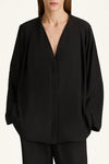 Black blouse with a deep neckline on a white background