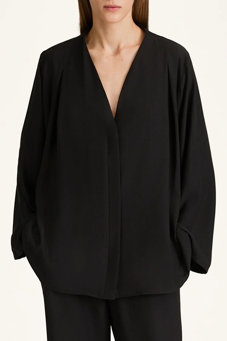 Black blouse with a deep neckline on a white background