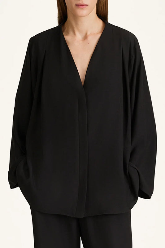 Black blouse with a deep neckline on a white background