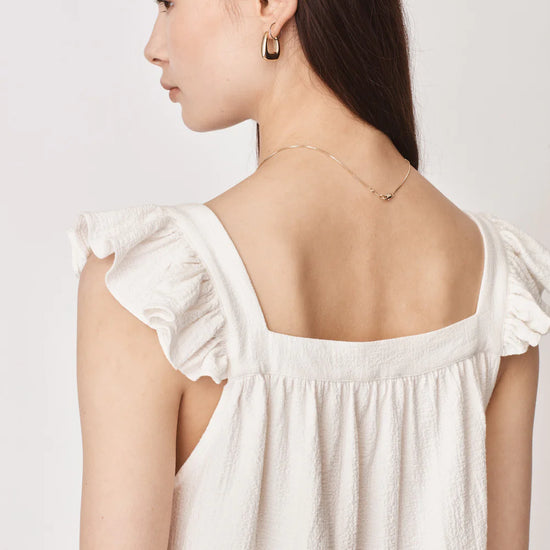 Ruffle capped sleeved top with square neck and backline in textured waffle like white ecru fabric