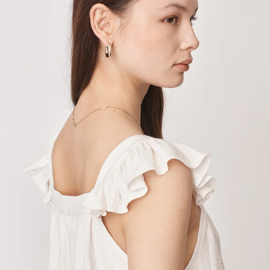 Ruffle capped sleeved top with square neck and backline in textured waffle like white ecru fabric