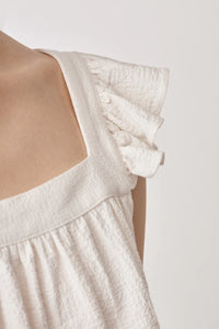 Ruffle capped sleeved top with square neck and backline in textured waffle like white ecru fabric