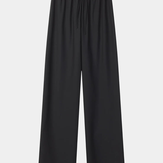 Black wide-leg cropped pants with an elastic waistband and drawstring, shown flat against a light gray background.