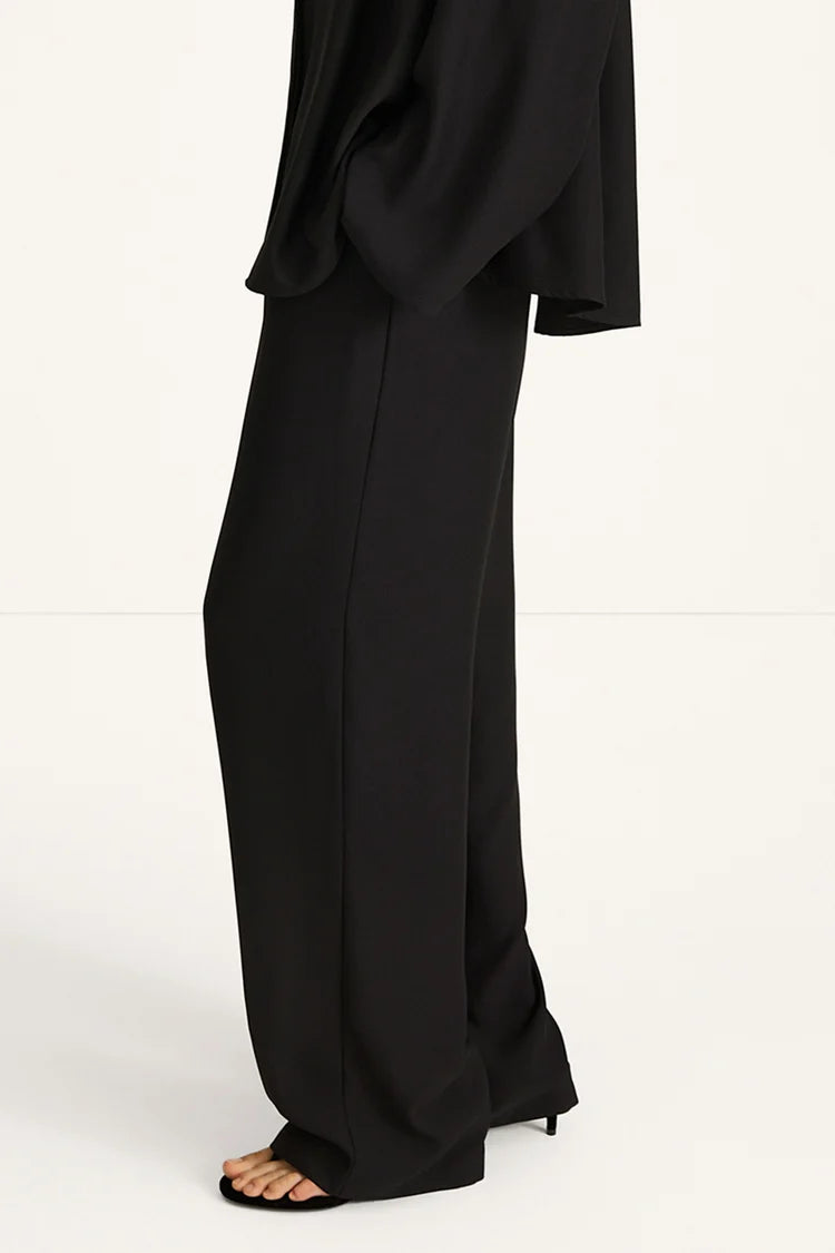Black outfit with wide-leg pants on a white background
