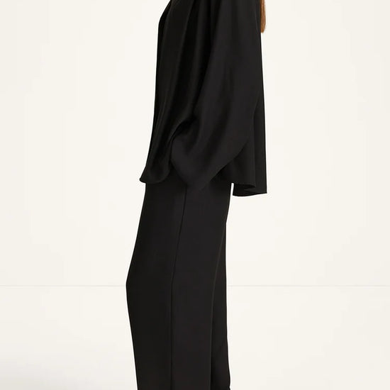 Woman wearing a black outfit on a white background