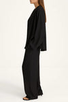 Woman wearing a black outfit on a white background