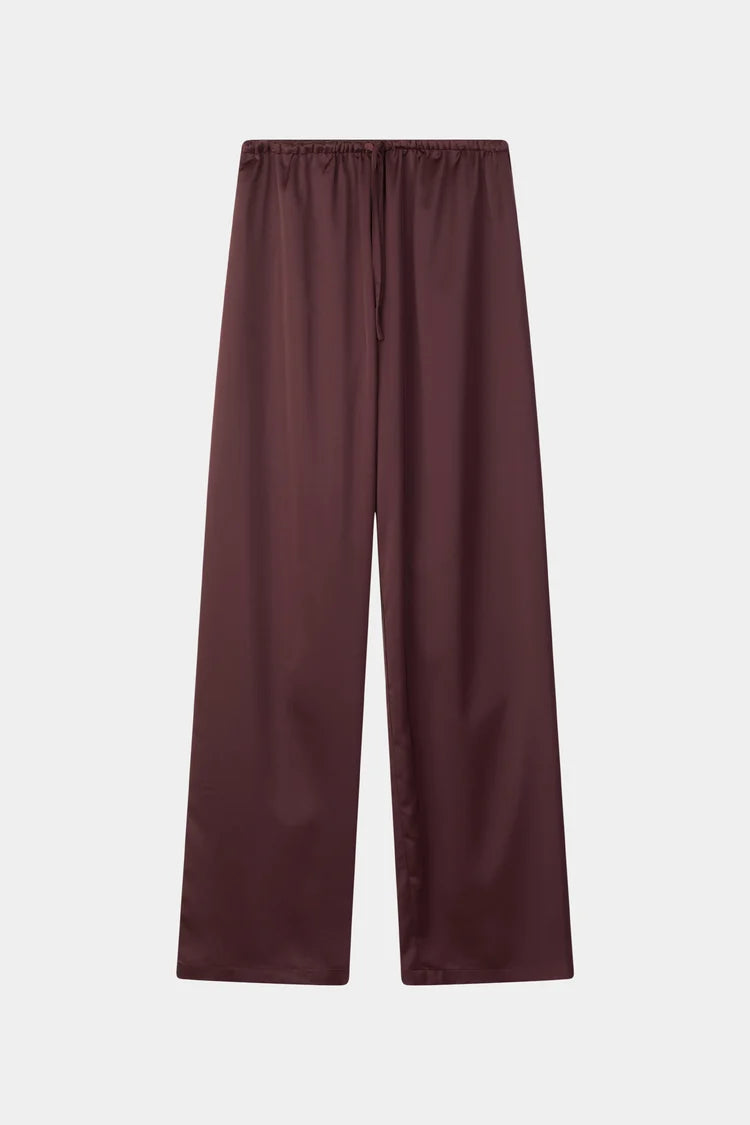 A pair of wide-leg trousers in a deep burgundy color, featuring an elastic waistband and a drawstring, shown flat against a light gray background.