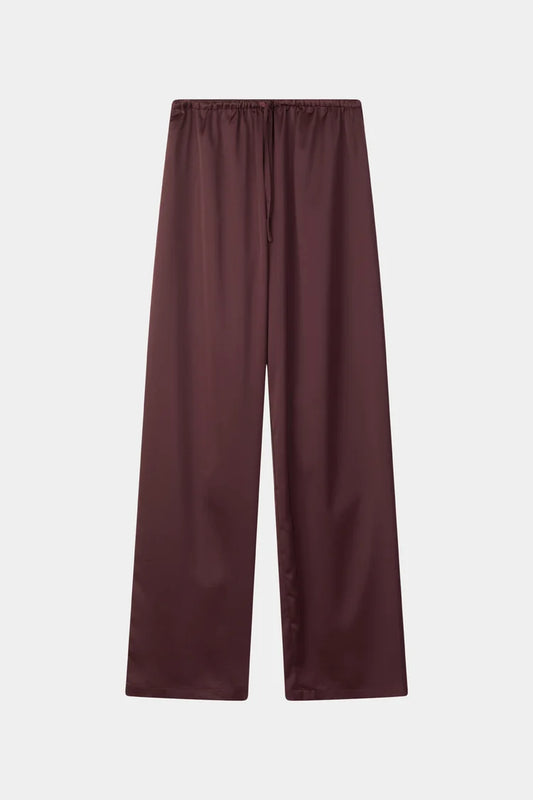 A pair of wide-leg trousers in a deep burgundy color, featuring an elastic waistband and a drawstring, shown flat against a light gray background.