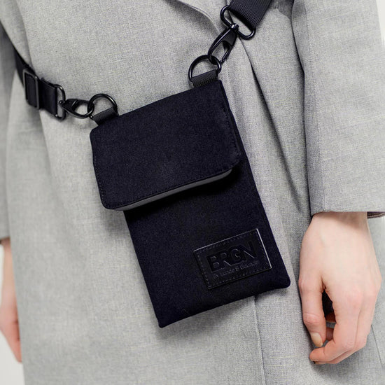 person modelling a black side bag