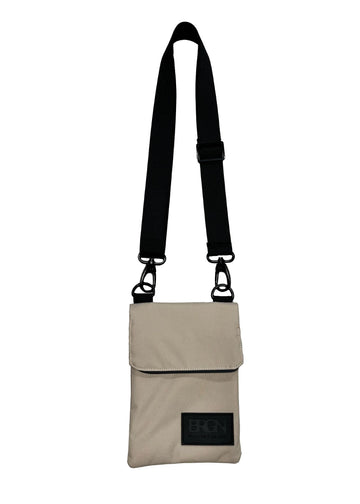 beige messenger purse with an adjustable black strap