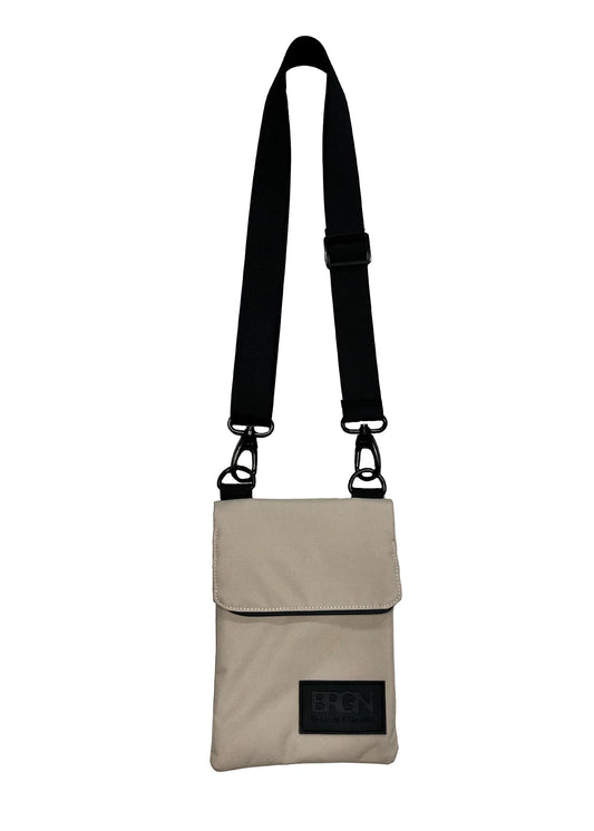 beige cross body bag on a white background