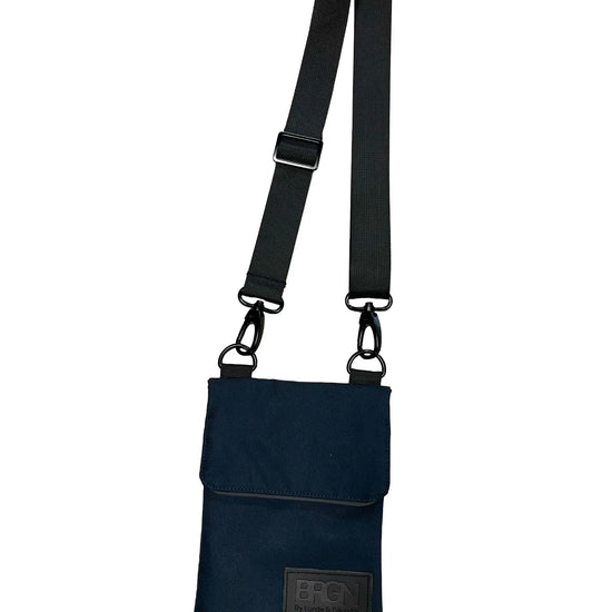 navy cross body bag on a white background 