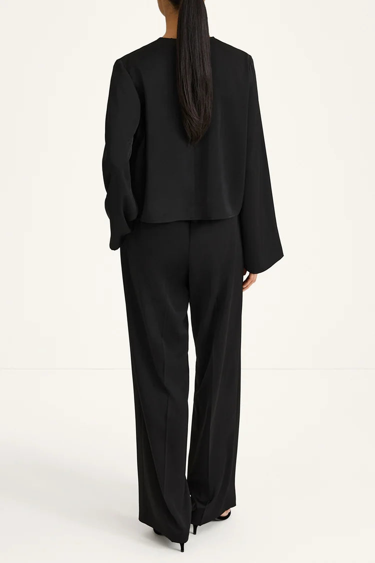 Person wearing a black suit on a white background