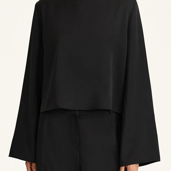Person wearing a black outfit on a white background