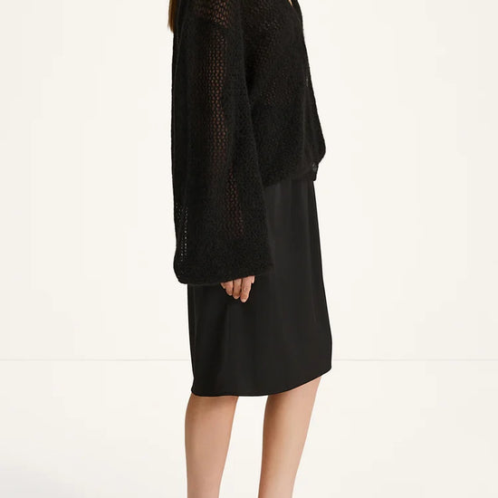 Woman wearing a black outfit on a white background