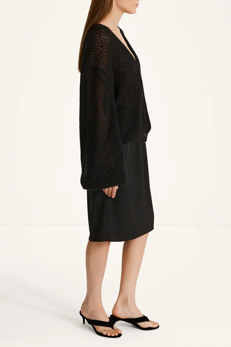 Woman wearing a black outfit on a white background