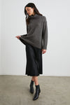 dark green roll neck jumper with ribbed cuffs, hem and neck with dropped shoulders m model shot 