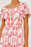 White dress with red floral pattern on a white background