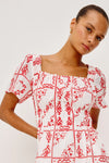 Close up of bodice of red and white embroidered dress