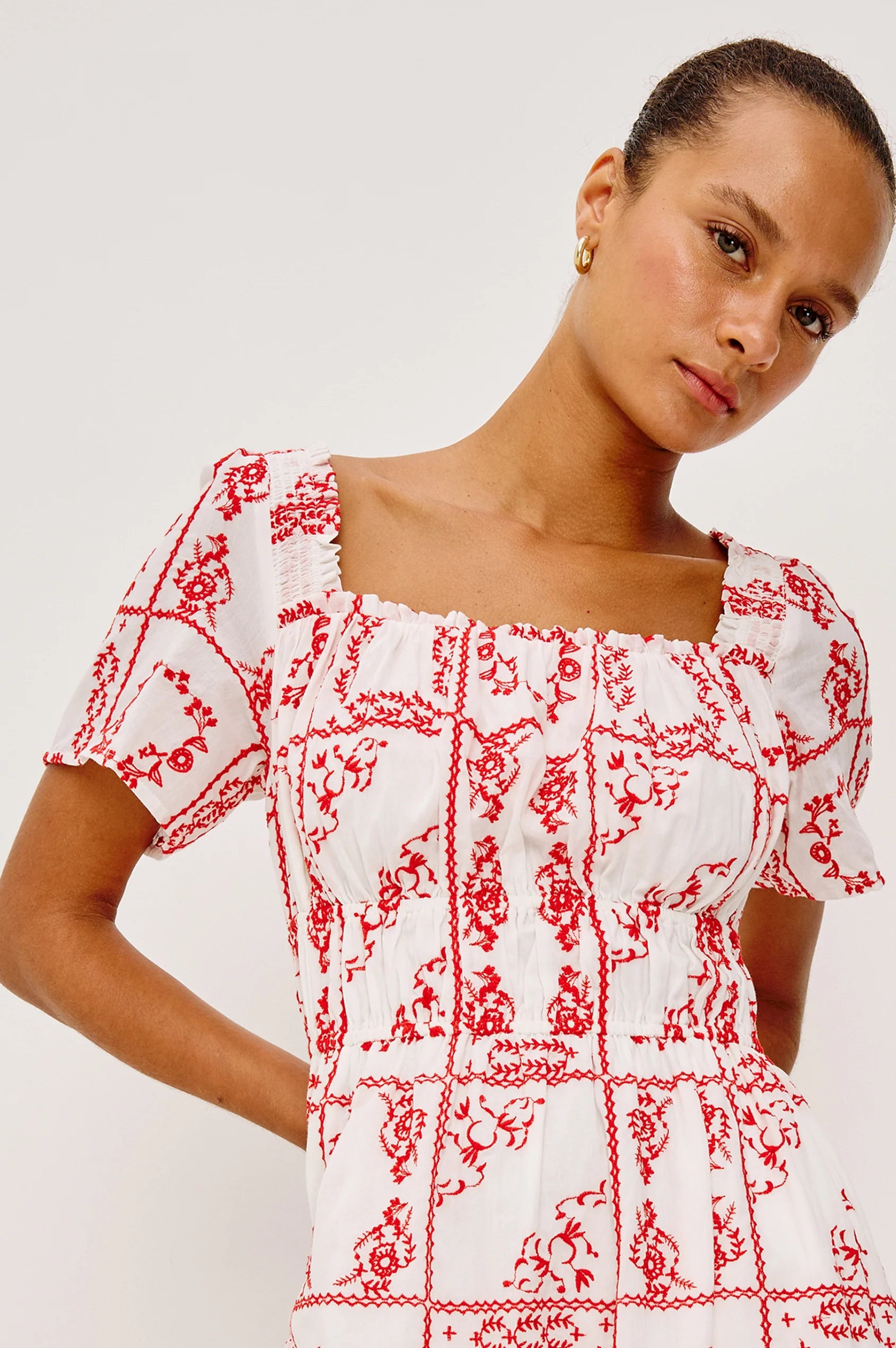 Close up of bodice of red and white embroidered dress