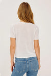 Woman wearing a white lace top by Rails and blue jeans on a plain background rear view